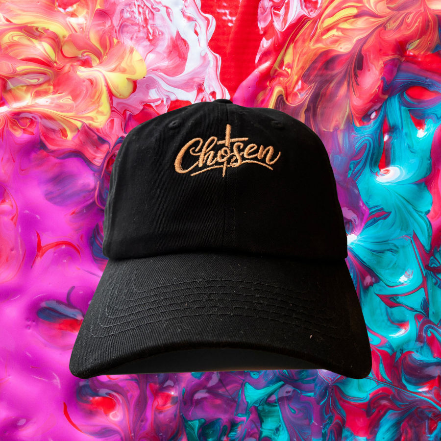 Black cap with 'Chosen' embroidery on a colorful abstract background